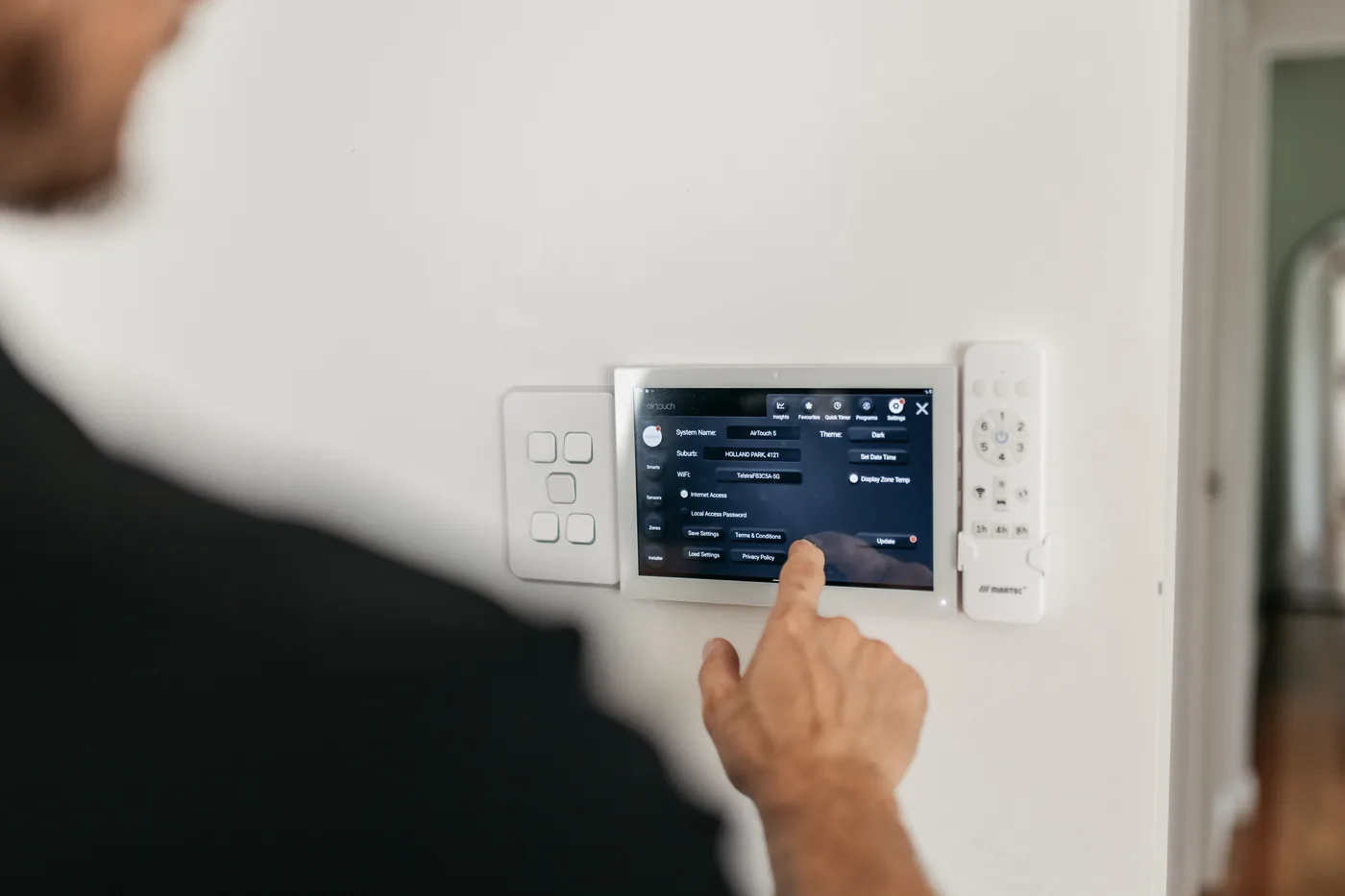AirTouch 5 ducted air conditioning zone controller with Clipsal Iconic switches installed in a Carina home by Moritz Electrical