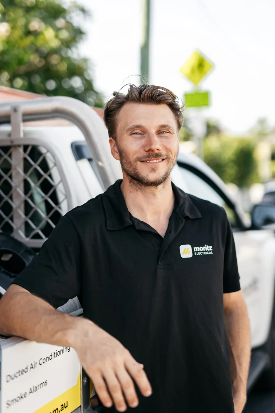 Dillon Moritz, licensed Brisbane electrician, with the Moritz Electrical ute